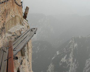 a deadly looking cliff with a wobbly bridge very high up in the mountains to symbolize the fiscal cliff